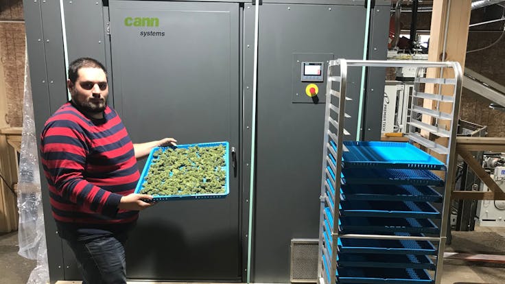 A CDS engineer in front of the CDS 2.5 door and touch screen controls