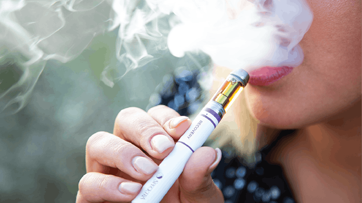 Woman using Specktra 300mg CBD vape recovery