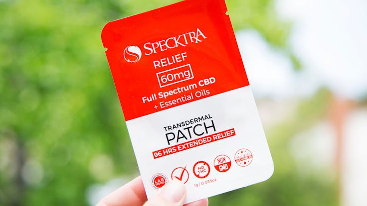 Person holding Specktra 60mg CBD transdermal patch