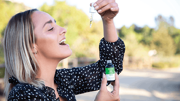 Woman using Specktra 250mg CBD tincture awake