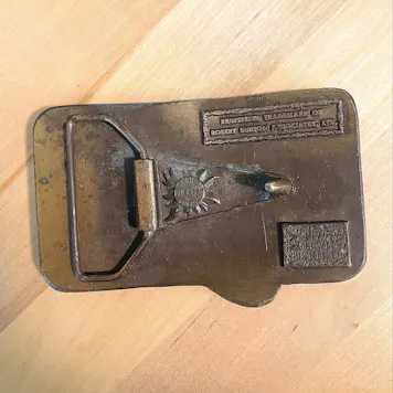 Photo of vintage e-z wider rolling papers belt buckle